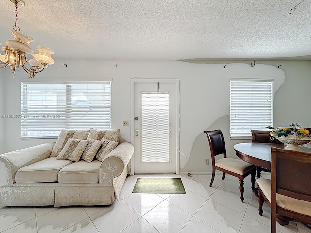 living room featuring a textured ceiling and a notable chandelier