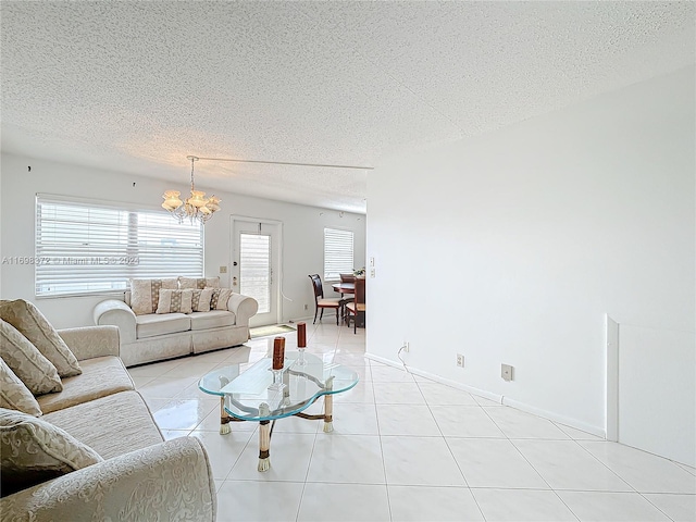 living room with light tile patterned floors, a textured ceiling, and an inviting chandelier