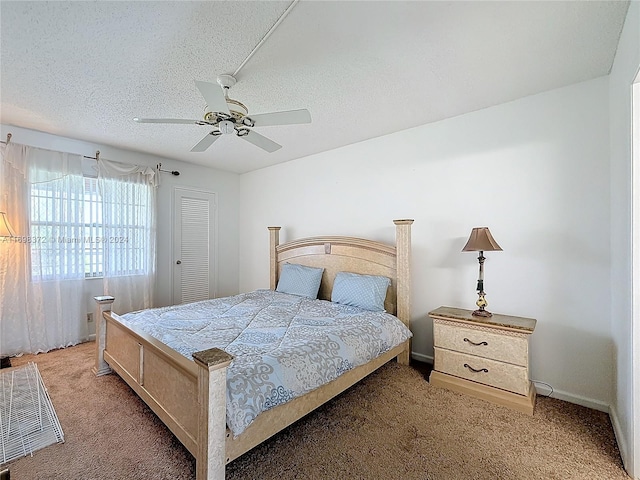 carpeted bedroom featuring a textured ceiling and ceiling fan