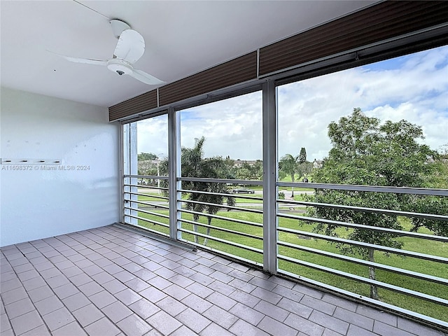 unfurnished sunroom with ceiling fan