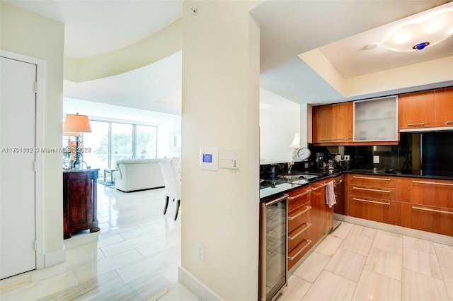 kitchen with decorative backsplash, sink, dark stone countertops, wine cooler, and light tile patterned flooring