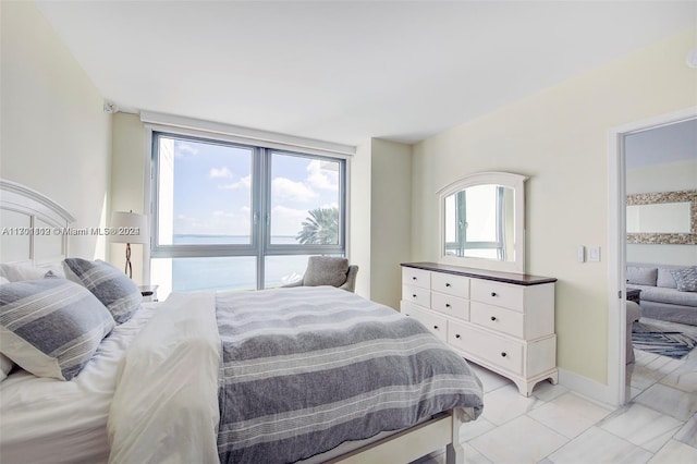 tiled bedroom featuring a water view