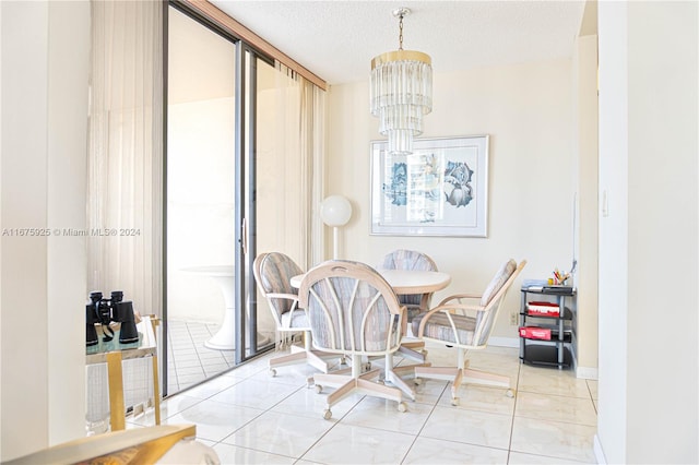 dining space featuring light tile patterned floors, a chandelier, and a textured ceiling