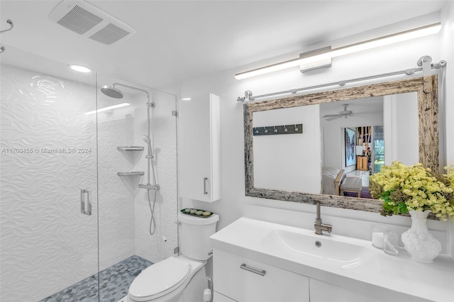 bathroom with ceiling fan, vanity, an enclosed shower, and toilet