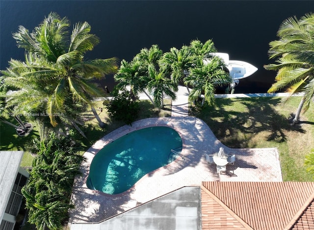 view of swimming pool with a water view and a patio