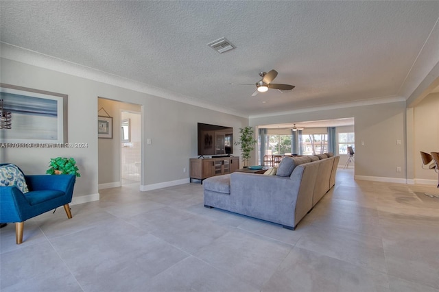 living room with a textured ceiling, ceiling fan, and ornamental molding