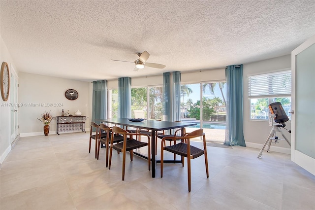 dining area with a textured ceiling and ceiling fan