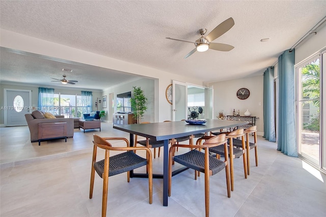 dining room featuring a textured ceiling, plenty of natural light, and ceiling fan