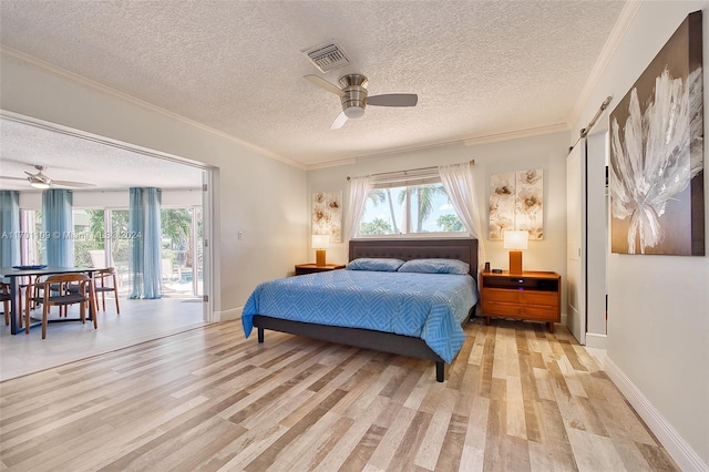 bedroom with ceiling fan, crown molding, light hardwood / wood-style floors, a textured ceiling, and access to outside