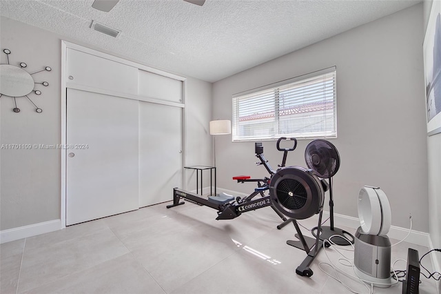 exercise room featuring a textured ceiling