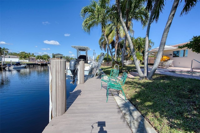 dock area featuring a water view and a lawn