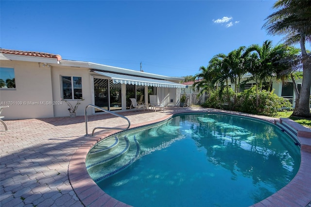 view of pool featuring a patio