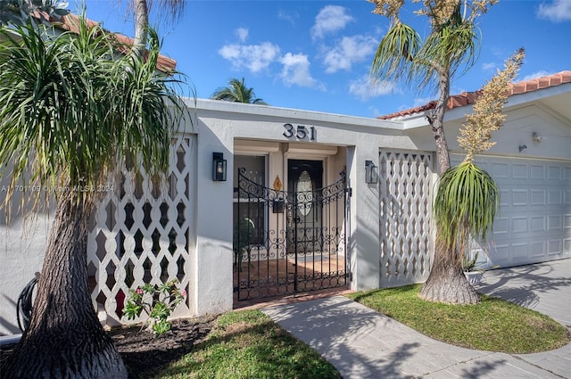 view of exterior entry with a garage