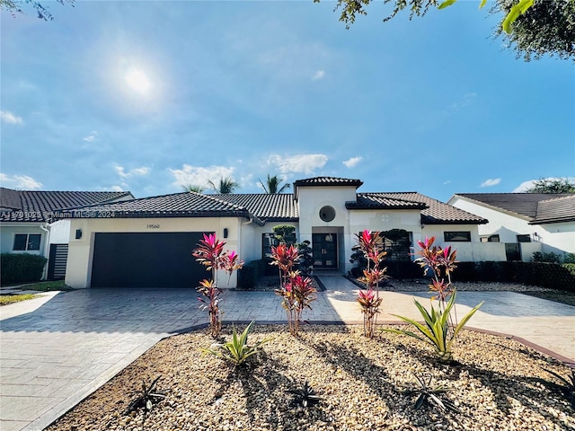 mediterranean / spanish-style home with a garage