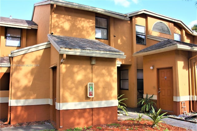2531 NW 56th Ave Unit 109, Lauderhill, FL 33313 - view of side of home with stucco siding and a shingled roof