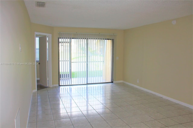 2531 NW 56th Ave Unit 109, Lauderhill, FL 33313 - empty room with light tile patterned floors and a textured ceiling