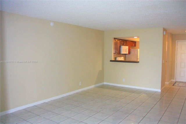 2531 NW 56th Ave Unit 109, Lauderhill, FL 33313 - unfurnished room featuring a textured ceiling and light tile patterned flooring