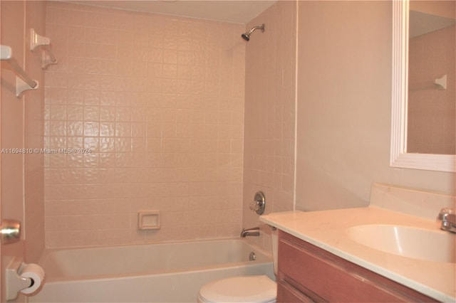 full bathroom with vanity, toilet, and tiled shower / bath