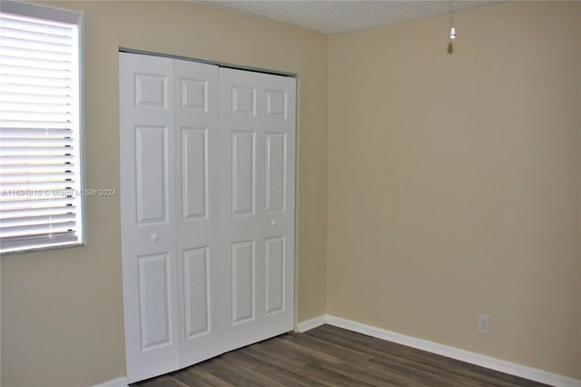2531 NW 56th Ave Unit 109, Lauderhill, FL 33313 - unfurnished bedroom with dark wood finished floors and a closet