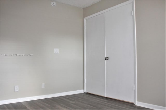 2531 NW 56th Ave Unit 109, Lauderhill, FL 33313 - unfurnished bedroom with dark wood-style flooring and a closet