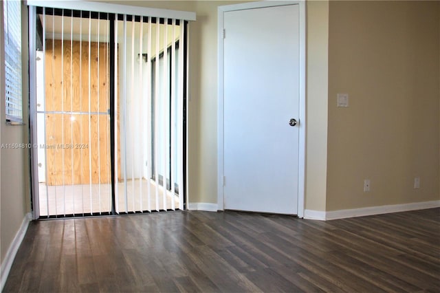 unfurnished room with a wealth of natural light and dark hardwood / wood-style floors