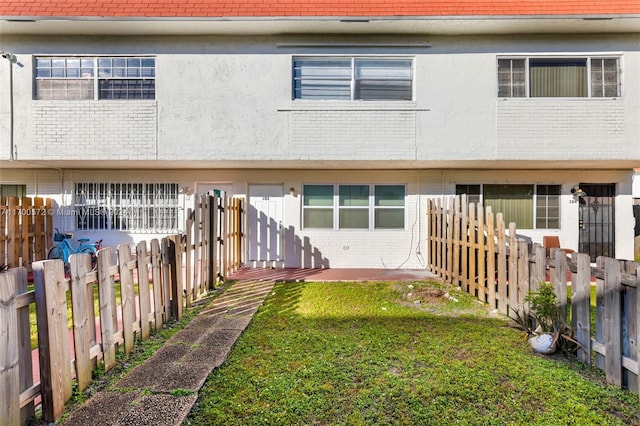 rear view of property with a patio area and a lawn