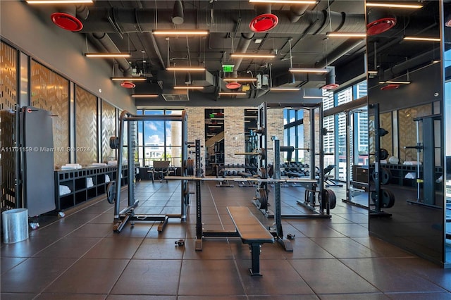 exercise room with a towering ceiling