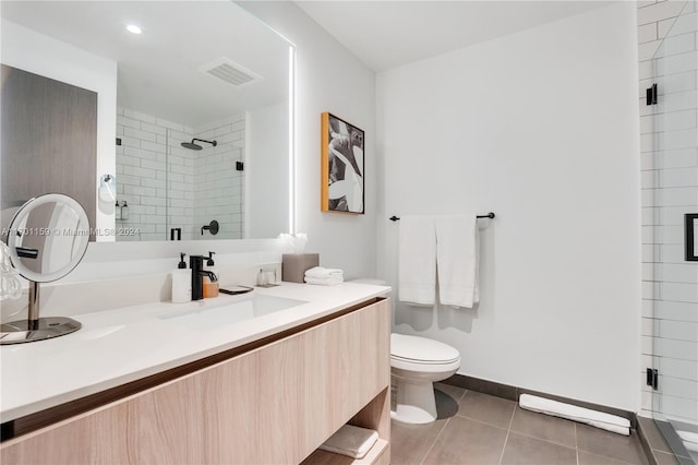 bathroom featuring walk in shower, tile patterned floors, vanity, and toilet