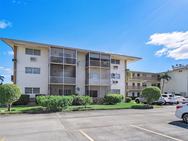 view of property featuring uncovered parking