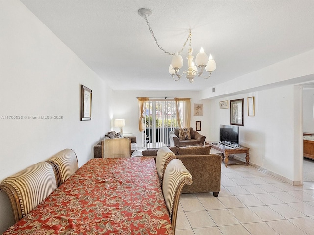 dining space featuring light tile patterned flooring and an inviting chandelier