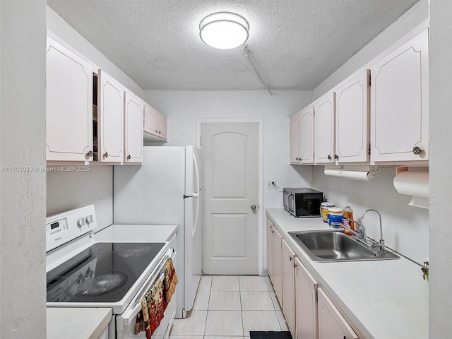 kitchen with white cabinets, a textured ceiling, white range with electric stovetop, and a sink