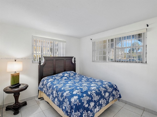 tiled bedroom with multiple windows