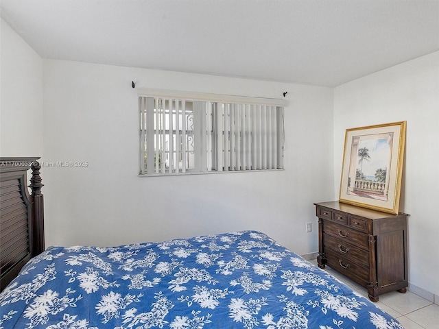 tiled bedroom featuring baseboards