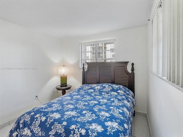 16701 NE 13th Ave Unit 101, Miami, FL 33162 - bedroom with tile patterned flooring and baseboards