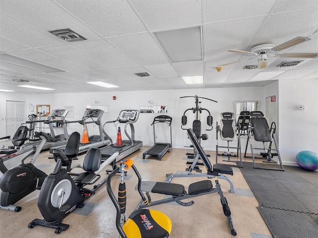 exercise room featuring ceiling fan and a drop ceiling