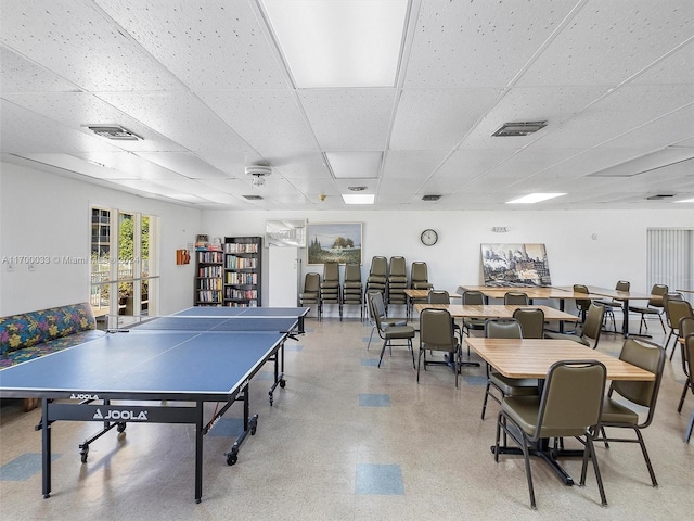 recreation room featuring a drop ceiling