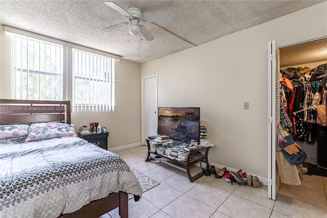 tiled bedroom featuring a textured ceiling, a closet, and ceiling fan