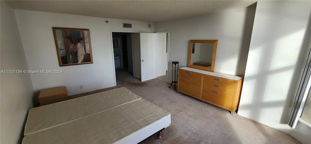 unfurnished bedroom with a textured ceiling and carpet floors