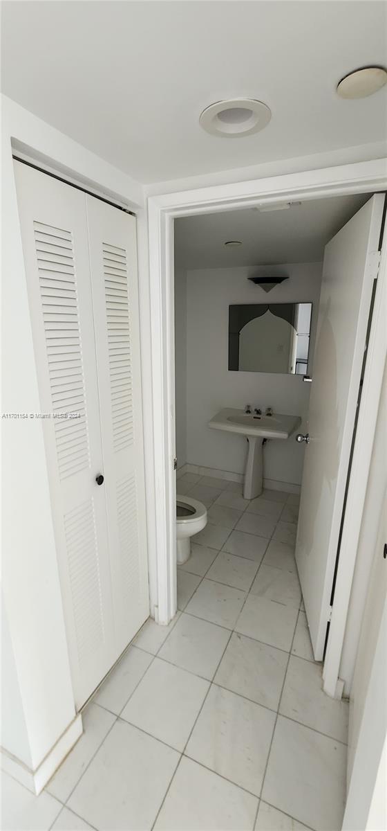 bathroom featuring tile patterned flooring and toilet