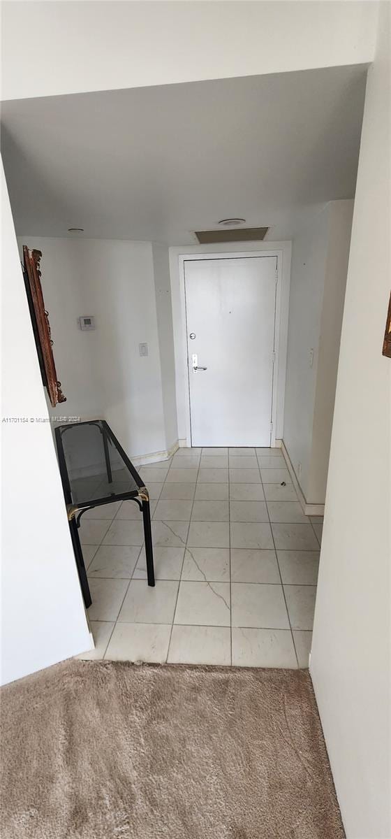 hallway with light colored carpet