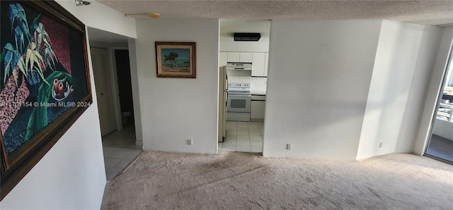 unfurnished room with light carpet and a textured ceiling