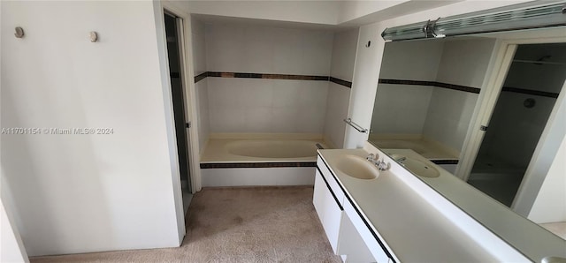 bathroom with vanity and tiled bath