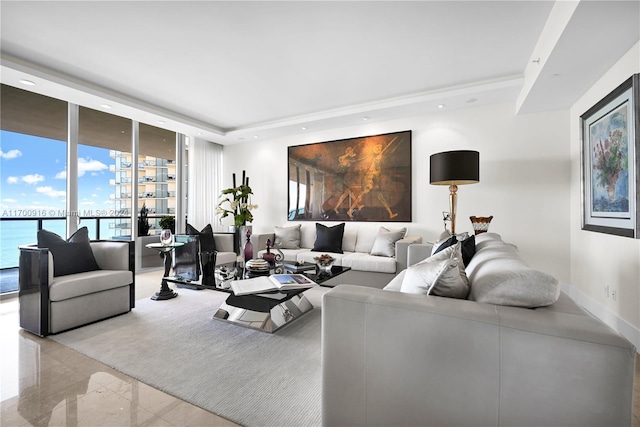 living room with a water view and a wall of windows