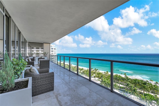 balcony featuring a water view and a view of the beach