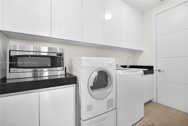 laundry area with light tile patterned flooring, sink, and washer / clothes dryer