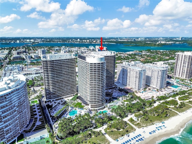 drone / aerial view with a beach view and a water view