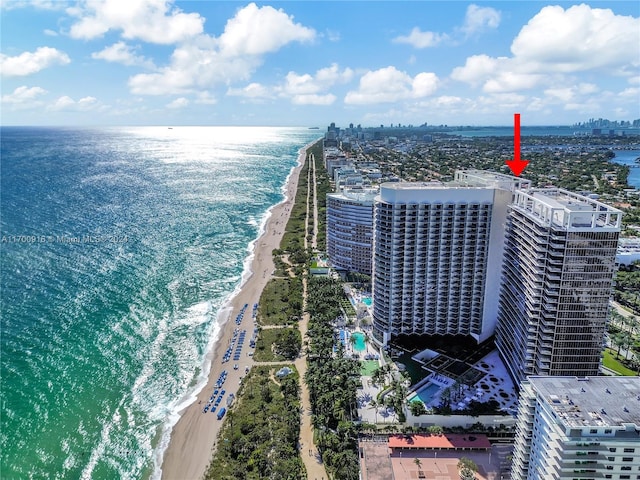 drone / aerial view featuring a water view and a beach view