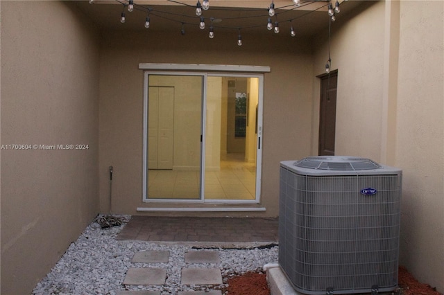 doorway to property featuring central AC unit