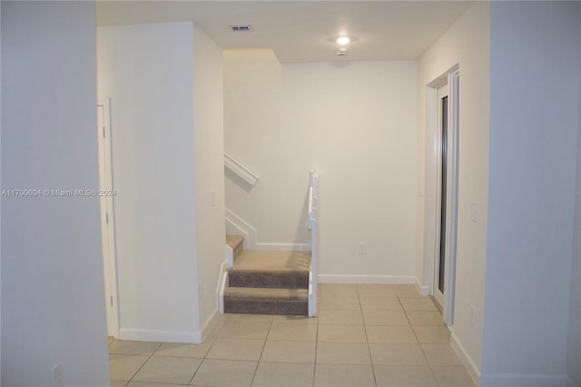 stairs featuring tile patterned floors