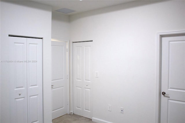 unfurnished bedroom featuring two closets